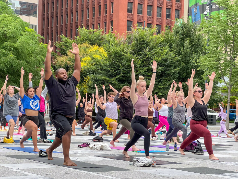 Participants practice yoga in Kiener Plaza